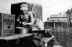 Signa Hermanson Larsen peeling potatoes for cooking, Burke County ND 1923