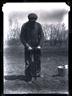 Man using corn drill 1925