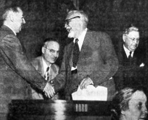 E.C. Stucke shakes hands with French Consul J.J. Viala