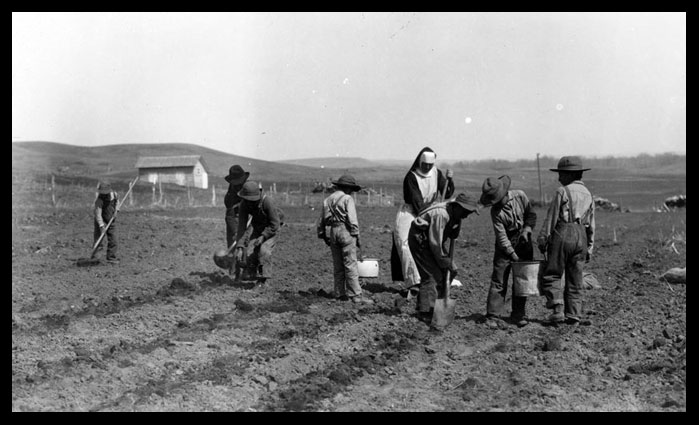 Sister Berthold and Indian boys gardening