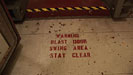 warning on floor blast door swing area