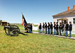 Reenactor troops with flag and cannon