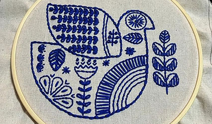 A bird embroidered in blue