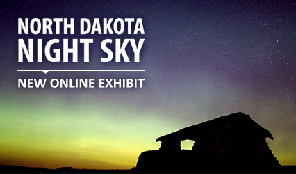 silhouette of building with northern lights in the background